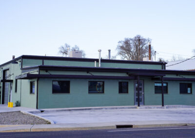 Green building exterior view from street.